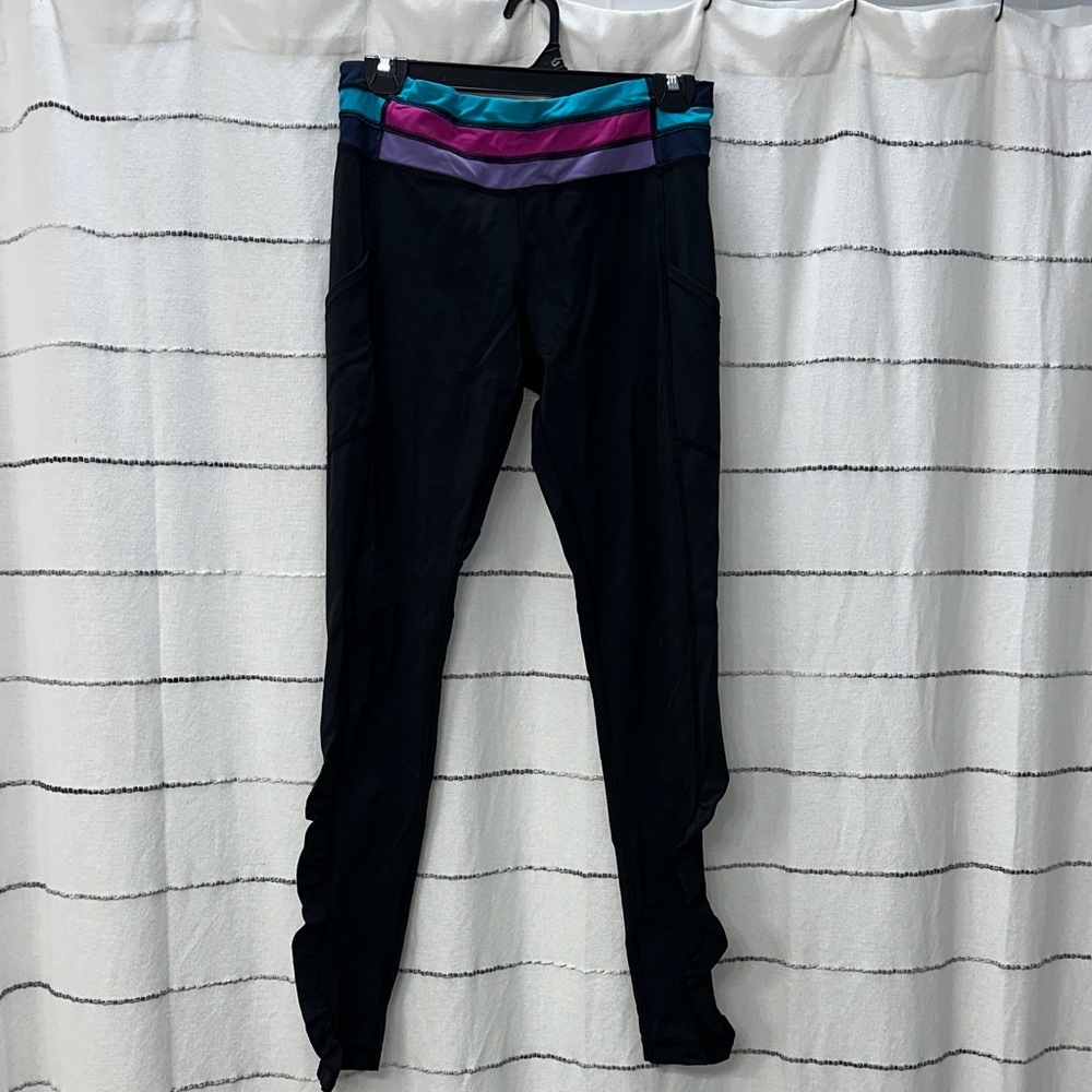 High waisted black leggings with color detail on the waist.